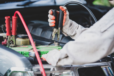 Mechanic repairing car engine in garage