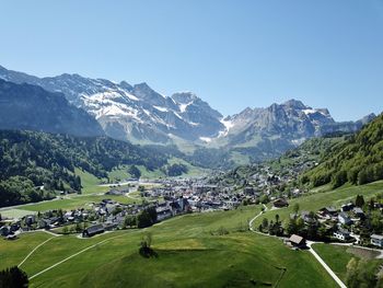 Scenic view of field and mountains against clear sky