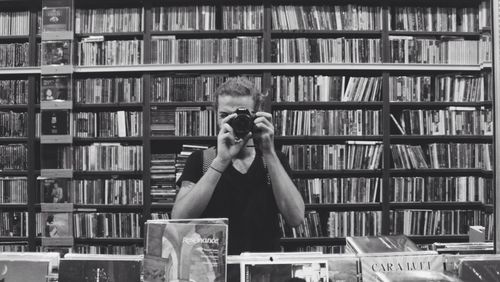 Portrait of woman photographing book