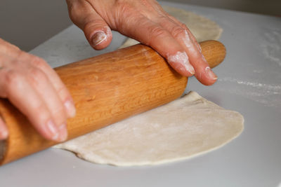 Close-up of hand holding ice cream on cutting board