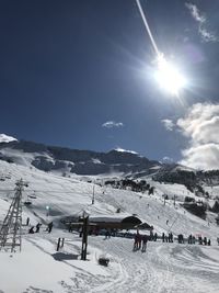 People on snowcapped mountain against sky