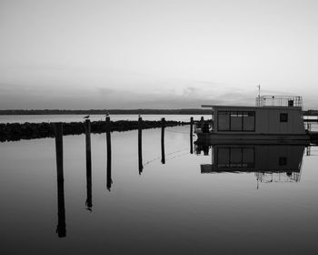 Reflection of building on sea against sky