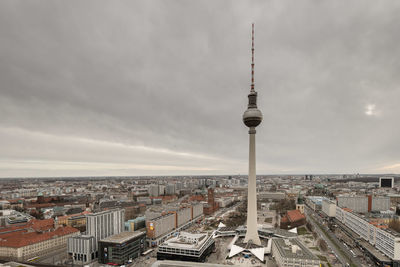 Aerial view of city buildings in berlin against cloudy sky