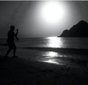 Silhouette of man standing on beach