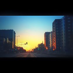 View of city street at sunset