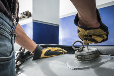 Low section of man working on table