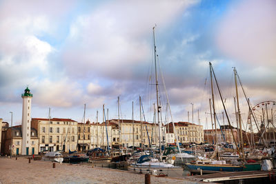 Sailboats moored in harbor