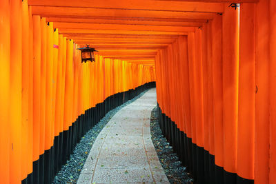 Orange shrine along empty footpath