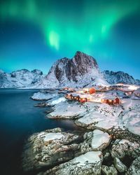 Scenic view of sea against sky at night during winter