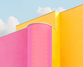 Low angle view of multi colored building against sky