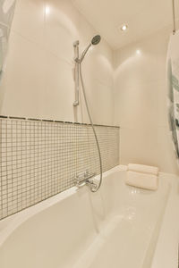 Low section of woman standing in bathroom