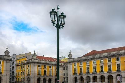 Low angle view of street light against building