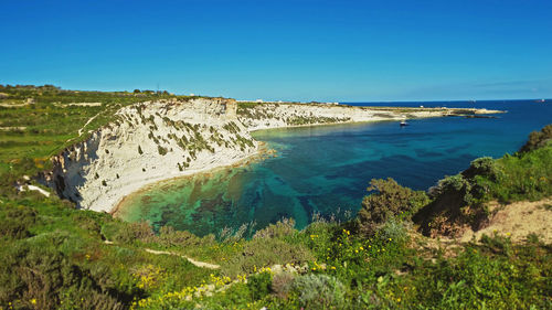 Scenic view of sea against clear blue sky