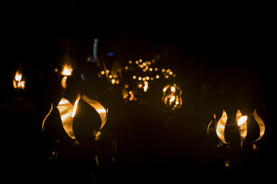 Close-up of illuminated lights in dark at night