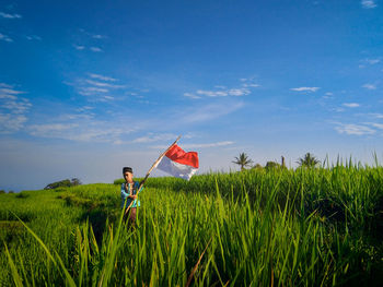 Man standing on field against sky