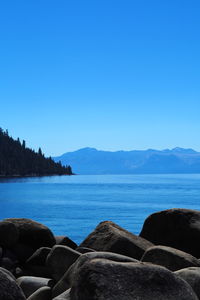 Scenic view of sea against clear blue sky