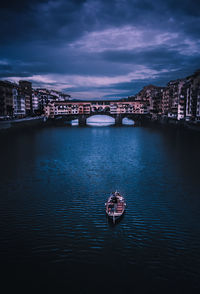 Bridge over river in city at night