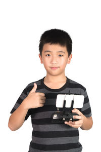 Portrait of boy standing against white background