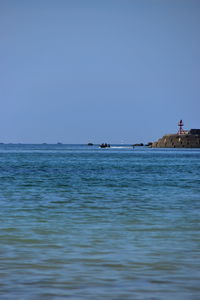 Scenic view of sea against clear blue sky