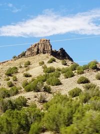 Low angle view of rocks against blue sky