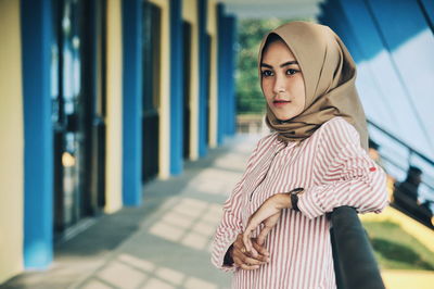 Close-up of woman wearing hijab while standing on corridor