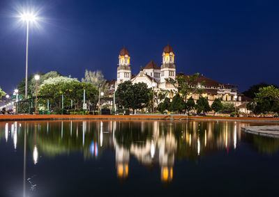 Reflection of illuminated buildings in water at night