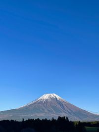 View of snowcapped mountain against blue sky