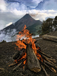 High angle view of fire on log against sky