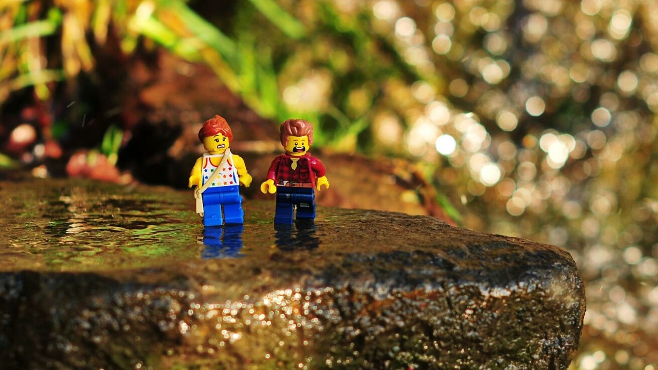 focus on foreground, selective focus, water, close-up, rock - object, multi colored, outdoors, stone - object, tradition, day, nature, spirituality, cultures, toy, tranquility, religion, no people, celebration, beach, art and craft