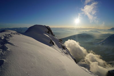 Scenic view of snow covered mountains against sky