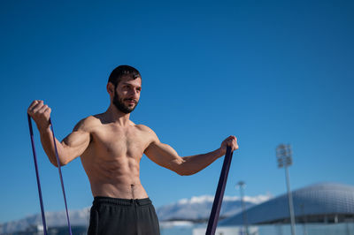 Low angle view of man standing against clear sky