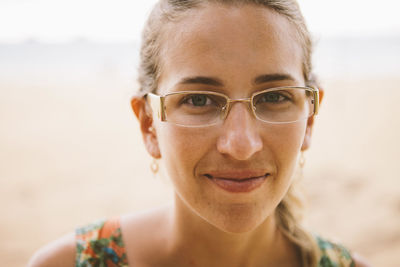 Close-up portrait of smiling woman at beach