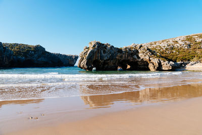 Beach of cuevas del mar, caves of the sea, llanes, asturias, spain