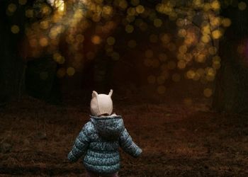 Little girl exploring woods