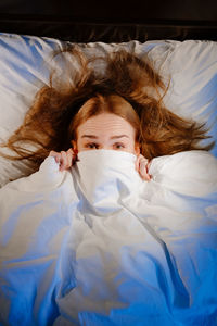 Portrait of a woman lying in bed