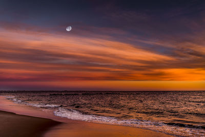 View of sea against cloudy sky during sunset