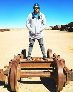 Full length of man standing on land against clear sky