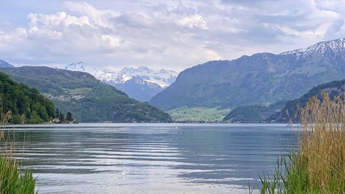 Scenic view of lake and mountains against sky