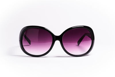 Close-up of sunglasses on glass against white background