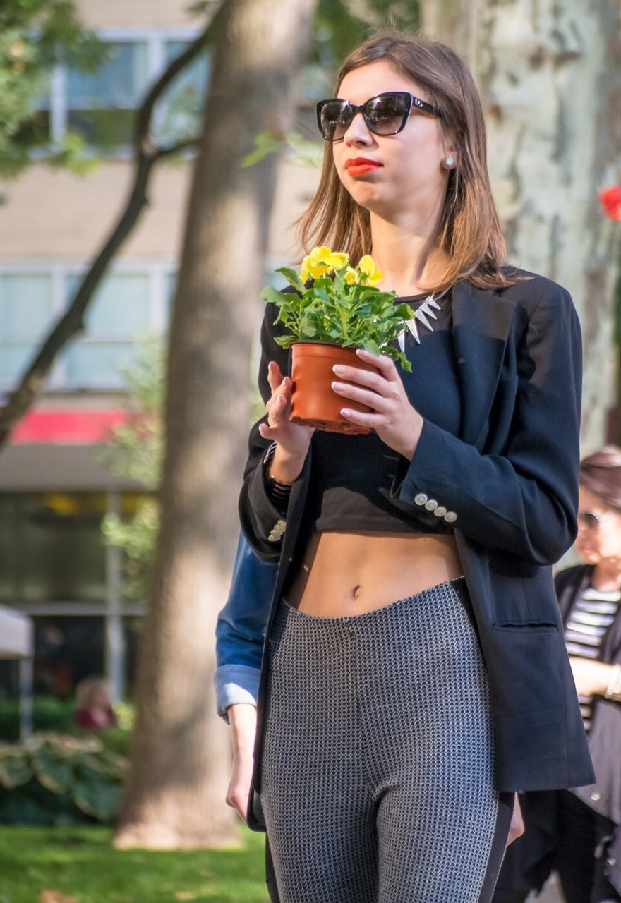 young adult, lifestyles, person, focus on foreground, casual clothing, leisure activity, young women, looking at camera, front view, portrait, standing, smiling, sunglasses, three quarter length, jacket, long hair, fashion