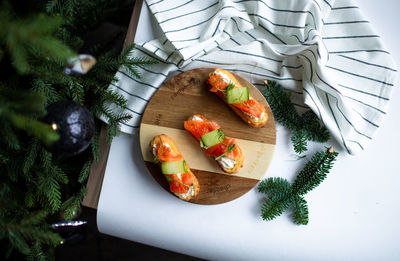 Eclairs with salmon, fresh vegetables and herbs, gourmet snacks.