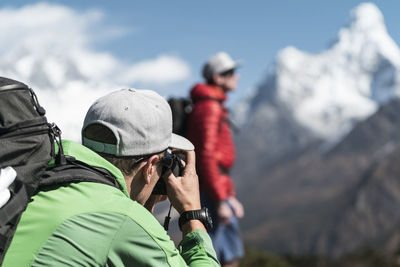 Man taking photos of friend on the ama dablam expedition, khumbu nepal