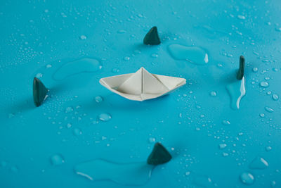 Close-up of water drops on blue paper