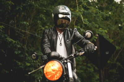 Man riding motorcycle outdoors