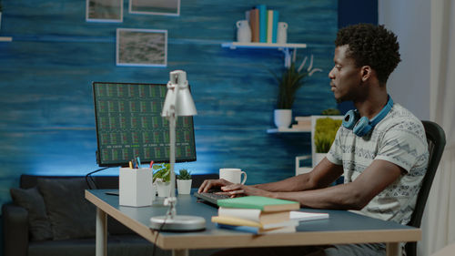 Young man using computer by table