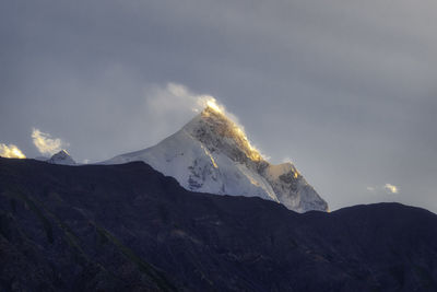 Scenic view of snowcapped mountains against sky