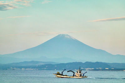 Sailboat in sea against sky