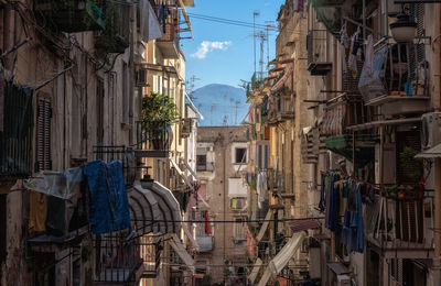 Street amidst buildings in town against sky