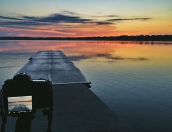 Scenic view of lake at sunset