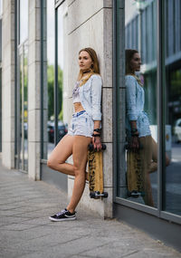 Full length of young woman in city